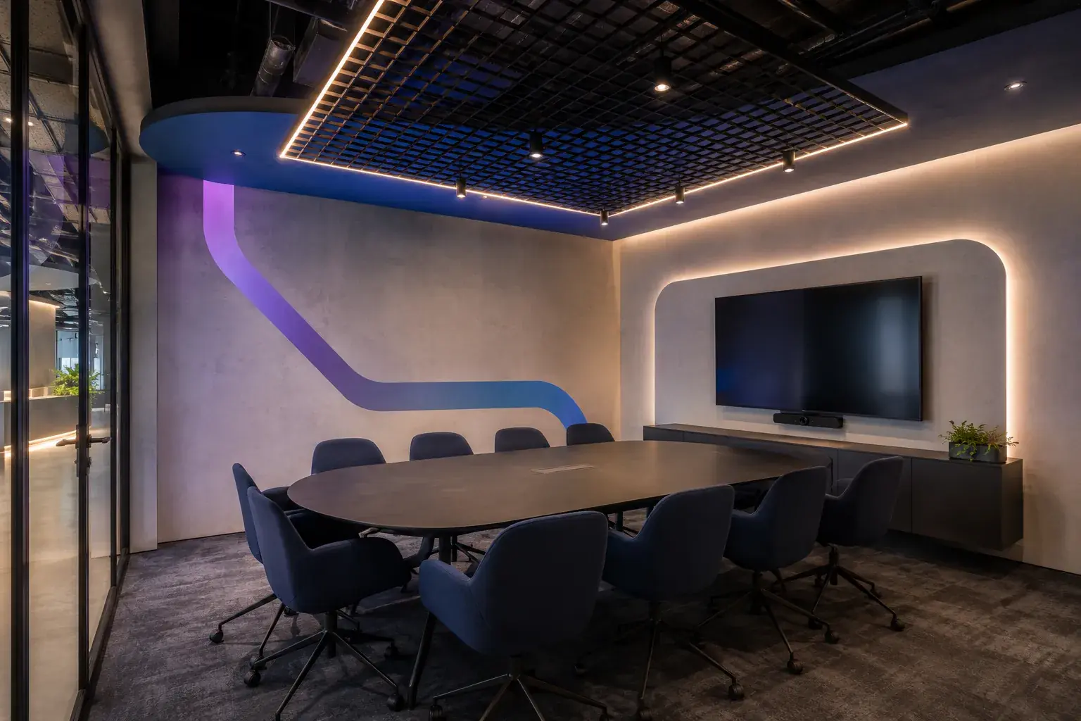Entwurfsvisualisierung Office: Besprechungsraum mit ovalem Konferenztisch, Medienwand und Lichtakzenten.